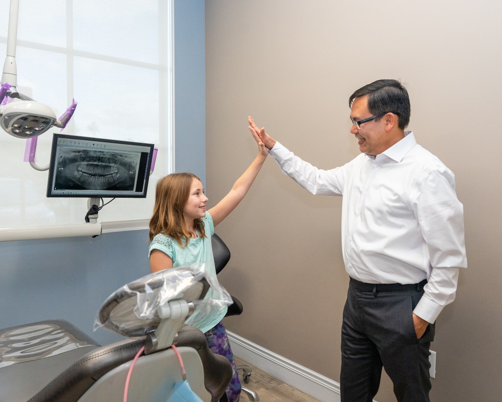 Dr. Vinh Le with kid patient